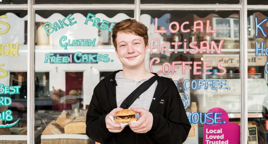 A student outside a local shop on Magdalen Road, near St Luke's Campus
